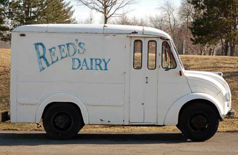 Vintage Reed's Dairy milk delivery truck with hand-painted blue lettering