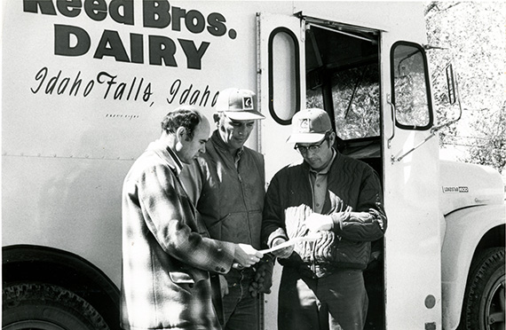 The three Reed founding brothers beside the Reed Bros. Dairy truck in Idaho Falls